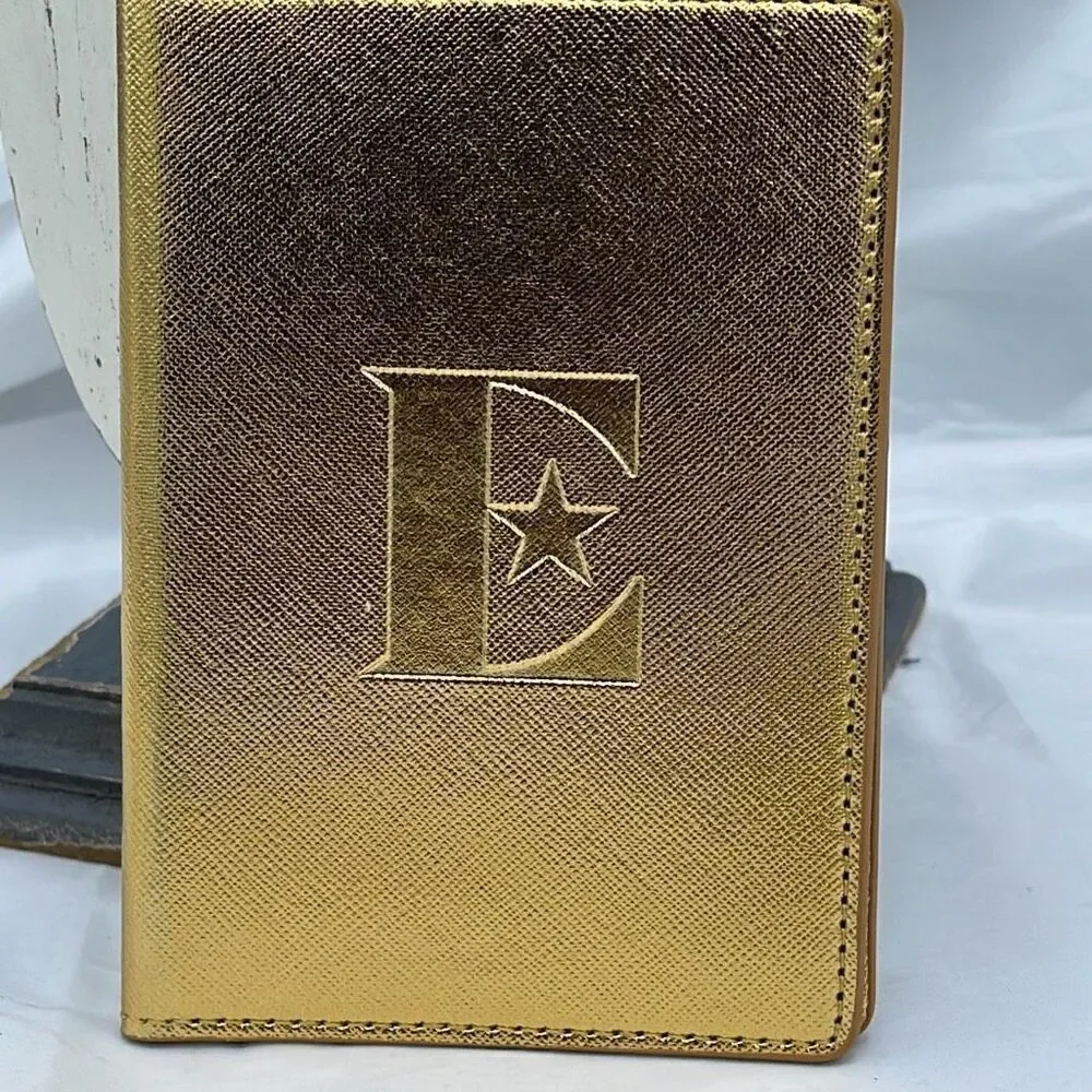 Vintage Elton John gold colored passport cover.